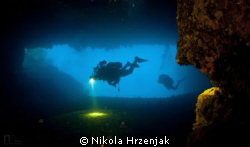 Divers in cave exploration by Nikola Hrzenjak 